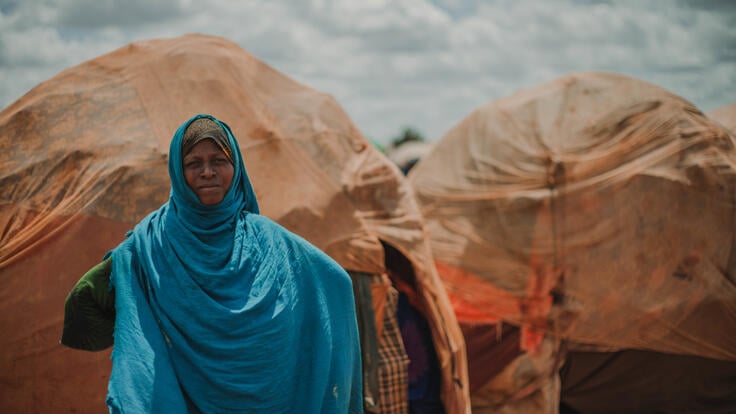 Bistra Abdullahi stands in front of her home in Tortorow camp in Somalia.